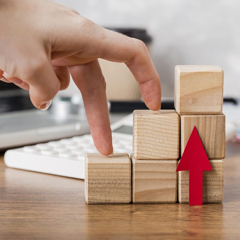 hand-climbing-wooden-blocks-represent-growth